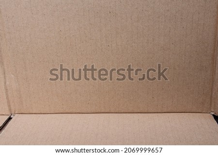 Textured pattern of brown paper box.