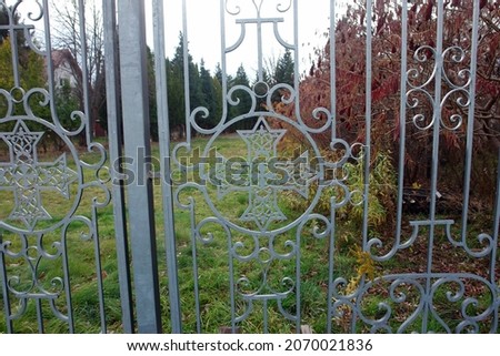 Monumental decorative entrance gate and fencing with religious symbols of the cross. Poland, Europe            