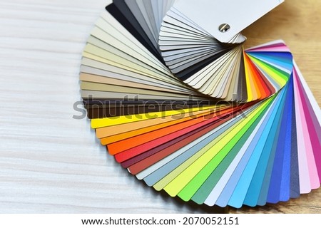 Color palette swatches. Palette of different colors and shades on wood background. Color catalog for tinting facade and interior paints, printing and painting and for wooden facades in furniture