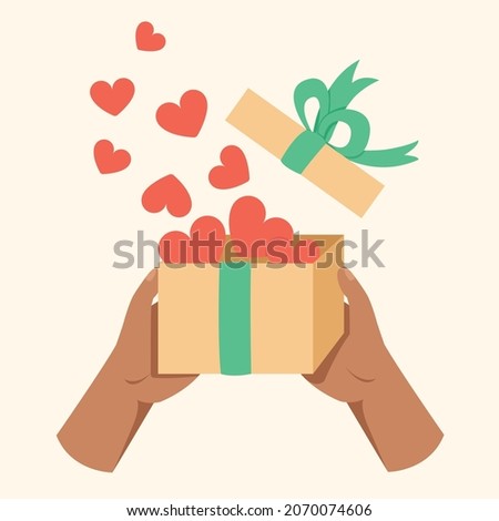 Hand holding gift box, opening box or unboxing with hearts concept.