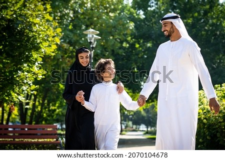 cinematic image of a family from the emirates spending time at the park Royalty-Free Stock Photo #2070104678