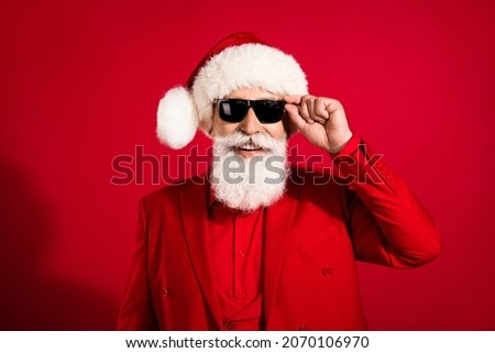 Photo of self-assured successful nice attractive santa claus wear sunglass x-mas headwear suit on red color background
