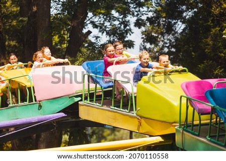 The children experience great emotions of roller coaster riding Royalty-Free Stock Photo #2070110558