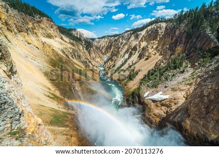 Rainbow over the waterfall. Amazing mountain landscape. Big waterfall among the beautiful rocks. Brink of  the Lower Falls on the Grand Canyon of  the Yellowstone, Yellowstone National Park, Wyoming Royalty-Free Stock Photo #2070113276