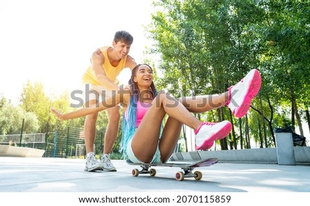 Group of skaters teens at the skatepark. Professional skateboarders having fun together