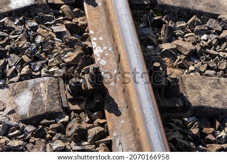 Close up view of railroad tracks, railroad ties. Crushed stones background on the railway. 
