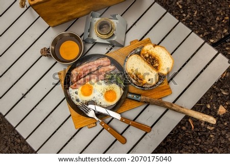 Simple cooking at the camp, fried egg on a bonfire Royalty-Free Stock Photo #2070175040