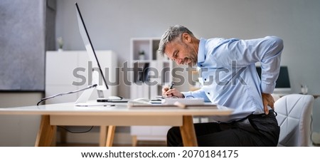 Man With Back Pain. Bad Office Posture Royalty-Free Stock Photo #2070184175