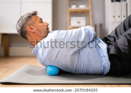 Back Trigger Point Massage Using Spiky Ball Myofascial Release Royalty-Free Stock Photo #2070184205