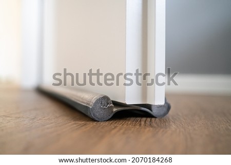 Door Draft Stopper Or Excluder. Stop Cold Air Royalty-Free Stock Photo #2070184268