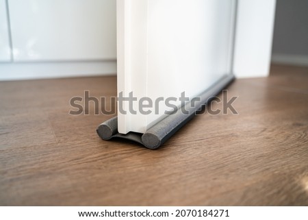 Door Draft Stopper Or Excluder. Stop Cold Air Royalty-Free Stock Photo #2070184271