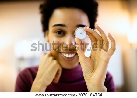 Woman Holding Continuous Glucose Monitor For Testing Glucose Level Royalty-Free Stock Photo #2070184754