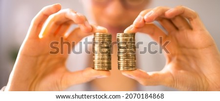 Compare Wage Gap, Money Pay And Equal Salary Royalty-Free Stock Photo #2070184868