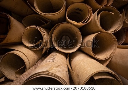 Ancient scrolls with futhpak symbols stacked on a pile. Ancient scribe library. View from inside. Parallax effect. Royalty-Free Stock Photo #2070188510
