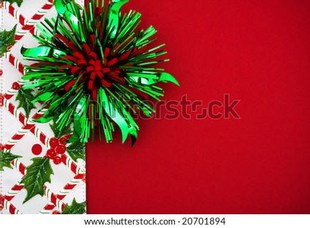 Green and Red bow with holly berries and leaf border on red background, Christmas border