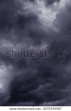 Epic Dramatic Storm sky with dark grey violet cumulus rainy clouds background texture, thunderstorm	
