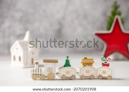 Attributes and symbols of the new year - locomotive, house and Christmas tree