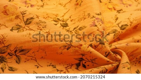 Yellow orange cotton fabric with floral print. Buy floral prints from independent artists and iconic brands. Texture, background,