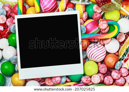 empty picture frame lies on sweets and candies