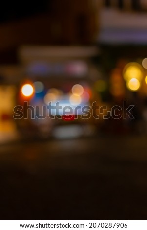 Blur texture background for design. Out of focus views of the city streets in the evening and at night. Cars and roads, headlights and colored lights.