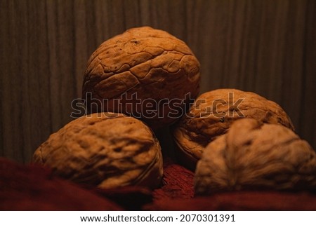 Close up picture of walnuts with walnut shell on red wooden. Walnuts wooden scene perfect lightning and walnut decoration. Vegan food nuts