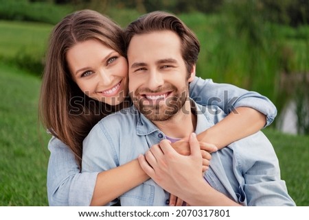 Portrait of smiling lovely good looking couple hug embrace relaxing outdoors enjoying summer vacation honeymoon Royalty-Free Stock Photo #2070317801