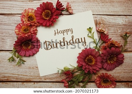 Happy Birthday card typography text with flower bouquet on wooden background