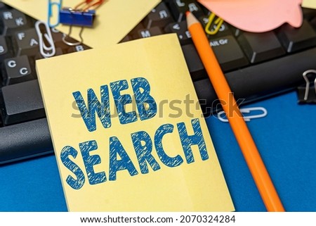 Hand writing sign Web Search. Business approach software system designed to search for information on the web Multiple Assorted Collection Office Stationery Photo Placed Over Table