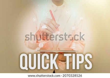 Hand writing sign Quick Tips. Business idea small but particularly useful piece of practical advice Business Woman Using Phone While Presenting New Futuristic Virtual Display.