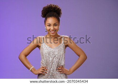 Confident sassy attractive african-american woman powerful pose hold hands hips smiling self-assured satisfied have excellent plan gonna take all feel fortune luck her side, blue background Royalty-Free Stock Photo #2070345434