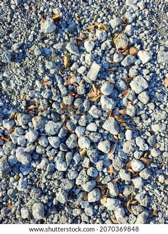 Crushed granite stones on the ground, background texture.