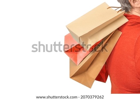 Senior woman holding shopping bags in hands isolated on white background
