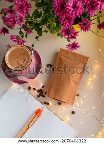 Kraft paper pouch bags coffee beans. Food packaging template mockup Pack clasp for tea leaves cocoa weight product. Cup chocolate pink autumn Chrysanthemum flower yellow pot on window. Cozy home vibes