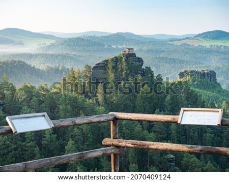 Tourist view platform with engraved map on Vilemina rock. Popular view point above forest landscape of Bohemia Switzerland national park in North of Czech Republic Royalty-Free Stock Photo #2070409124