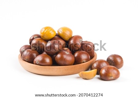 Close-up Chestnuts with peeled  isolated on white background. Royalty-Free Stock Photo #2070412274