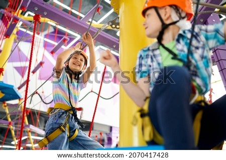 Happy children on zip line in entertainment center Royalty-Free Stock Photo #2070417428