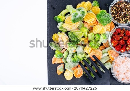Mix of frozen vegetables on black. Studio Photo