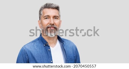 Handsome mature man close-up portrait, isolated on gray background. Middle age man looking at camera. Male beauty, active seniors, modern lifestyle, people concept Royalty-Free Stock Photo #2070450557