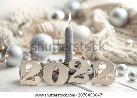 Christmas background with decorative 2022 numbers and cozy details.