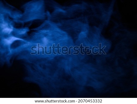 blue smoke, fog or steam on a black background