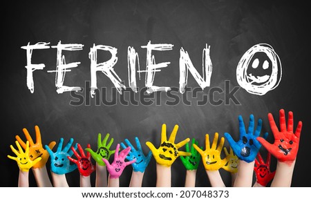 colored children hands with the word "vacation" in German