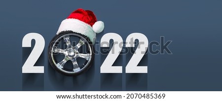 2022 Auto wheel in Santa's hat. New Year banner for auto workshop, auto shop. Copy space. Place for your text. Business. Background. Royalty-Free Stock Photo #2070485369