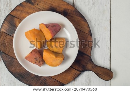 Steamed sweet potato, healthy snack for tea or coffee time and also brunch. Picture in top view or flatlay on wooden board and white background