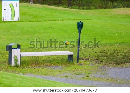 Close up - Golf ball station for washing dirty golf balls. Green background. High quality photo