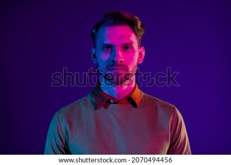 Photo of serious young cool charming attractive man wear casual outfit club isolated on neon background