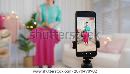 Asia vlogger woman influencer, SME retail store owner smile enjoy selling show live sale online screen in IG story reel tiktok work at home studio. Gen Z people record viral video selfie shoot app. Royalty-Free Stock Photo #2070498902