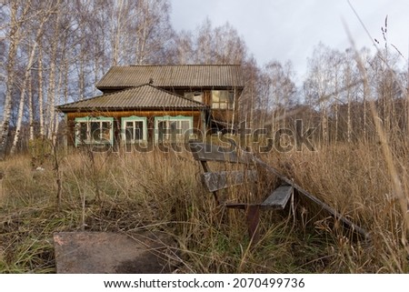 An old wooden house in the village in the autumn season.