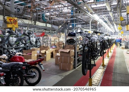 assembly line in a motorcycle factory, manual labor