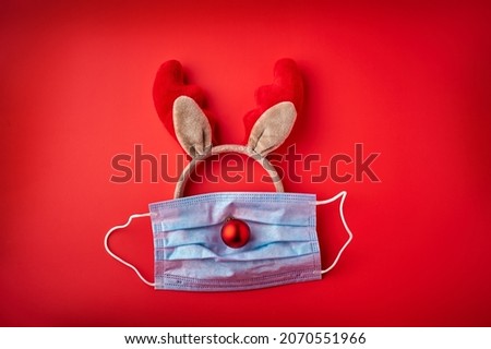 Festive christmas reindeer made face protective mask and christmas decorations, Covid-19 Christmas festival celebration concept.