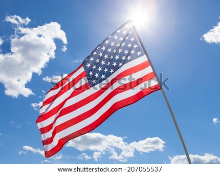 USA flag waving on blue sky background